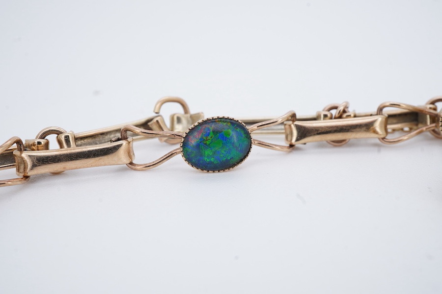 An opal triplet bracelet and pair of earrings, comprising: a gold bracelet set with opal triplets, length 18cm; and a pair of studs set with opal doublets, mounted in gold, length 0.8cm each, post fittings, stamped 585,